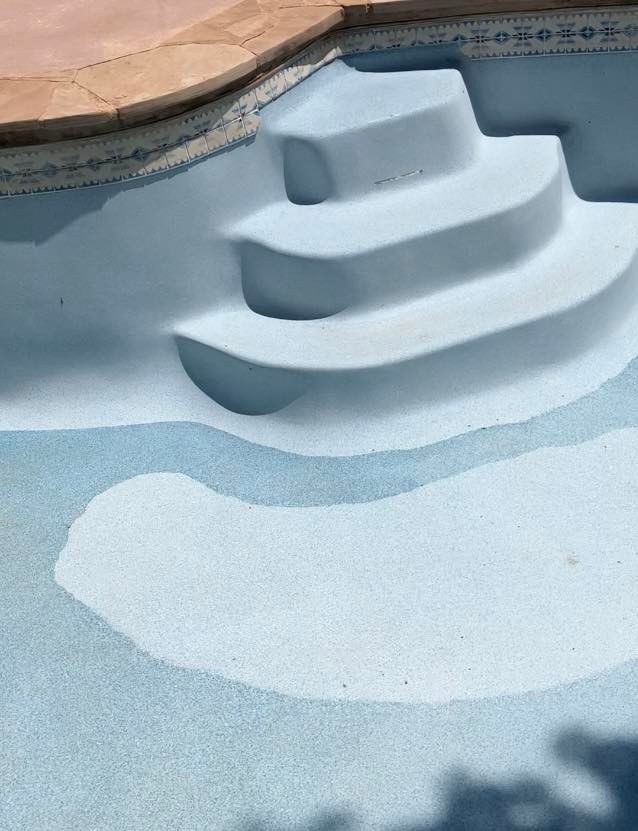 Dated pool resurfaced with new plaster and waterline tile — after