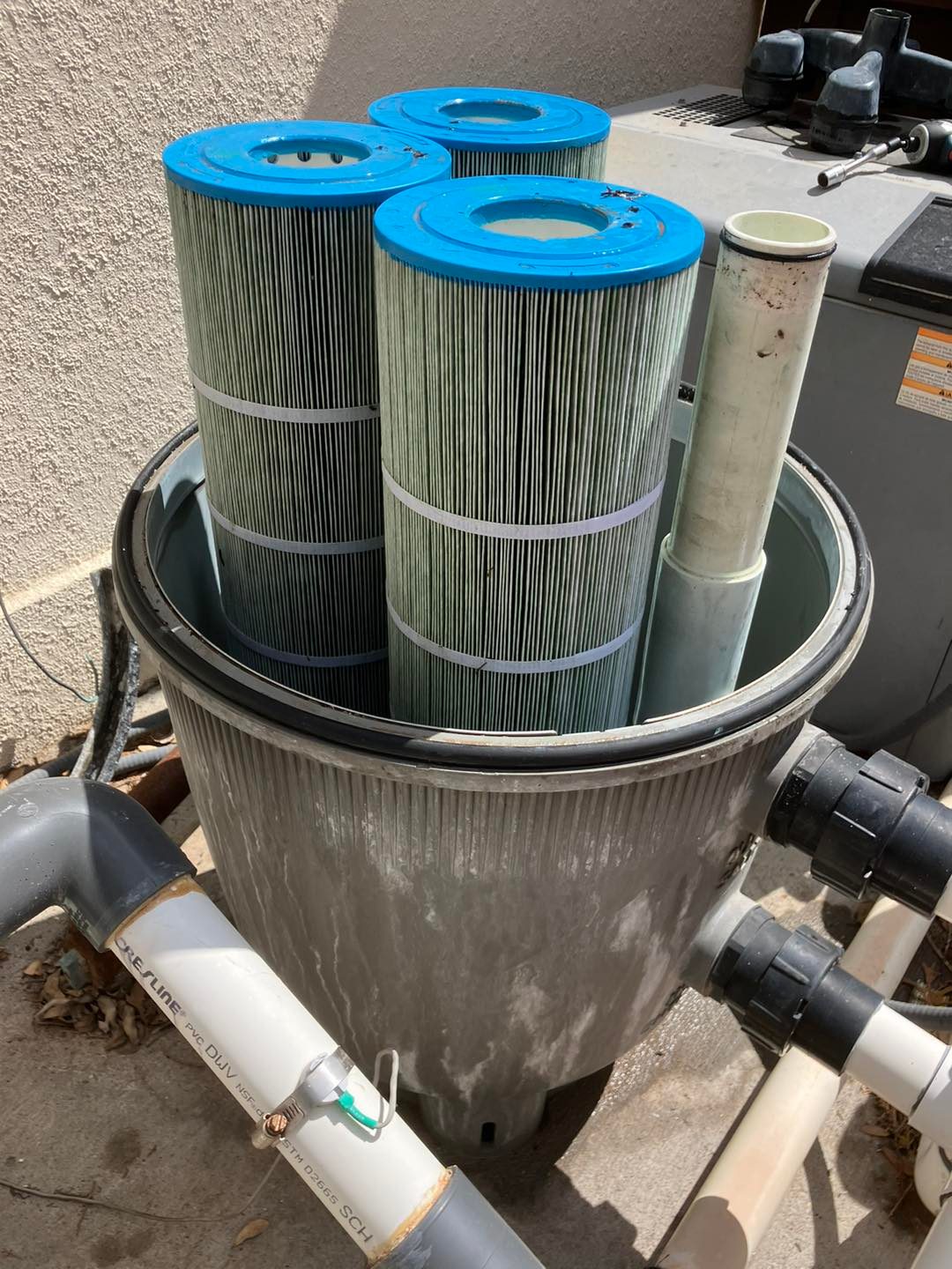 Failed equipment pad rebuilt with a new pump and filter — before